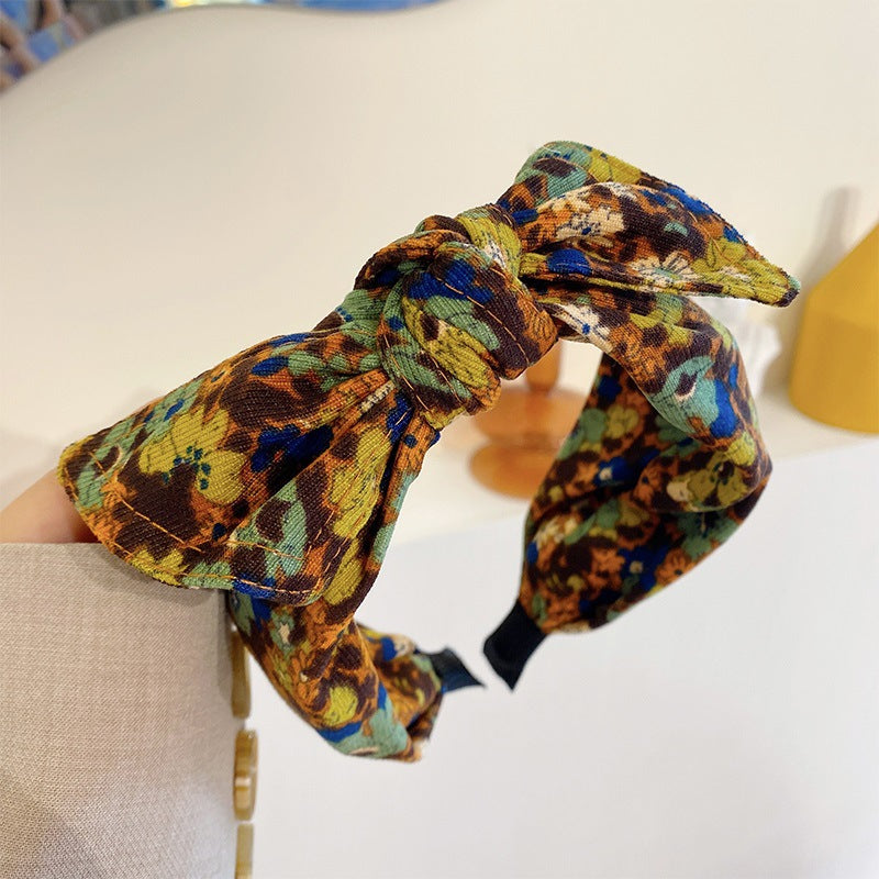 Simple Wide-brimmed Fabric Hairband With A Printed Pattern And A Tied Knot